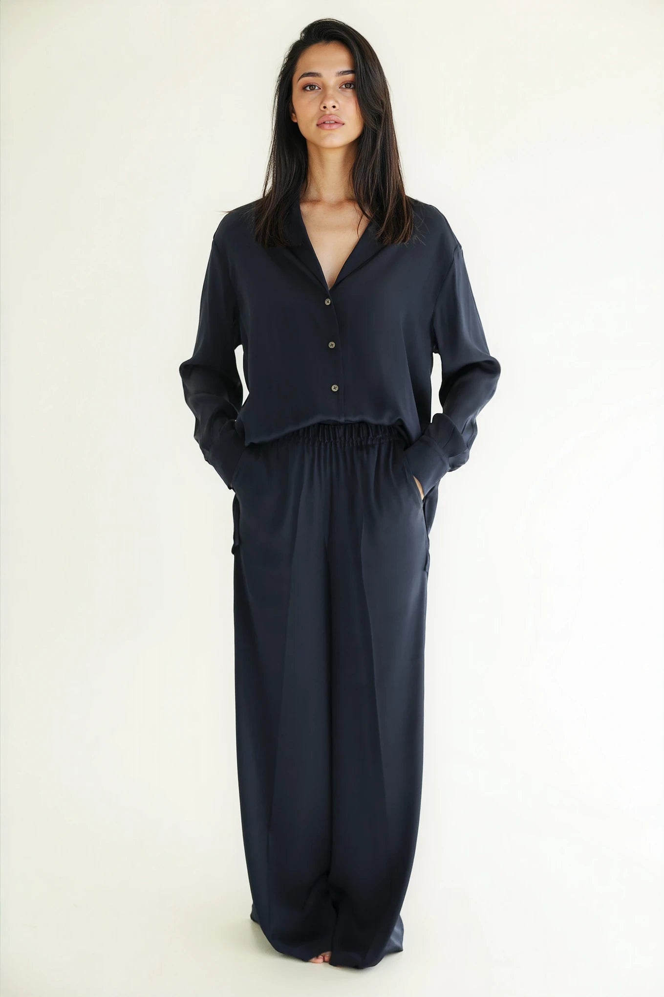 Woman wearing a dark blue outfit on a white background